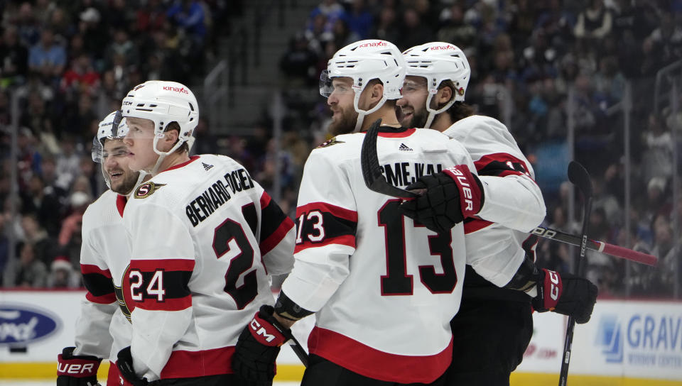 Ottawa Senators defenseman Jacob Bernard-Docker, front left, is congratulated by defenseman Erik Brannstrom, back left, left wing Jiri Smejkal, front right, and center Mark Kastelic for his goal against the Colorado Avalanche during the second period of an NHL hockey game Thursday, Dec. 21, 2023, in Denver. (AP Photo/David Zalubowski)