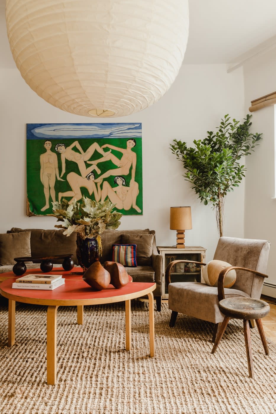 “There’s not really a go-to source for affordable artwork and small objects,” says Jonny, who hopes to fill that void. “I’m less interested in who made it and more interested in what it is.” A 20th-century oil painting by Thomas Barrett hangs above the custom sofa in his living room, which also features Alvar Aalto tables, a primitive stool from France, and an Isamu Noguchi Akari lantern.