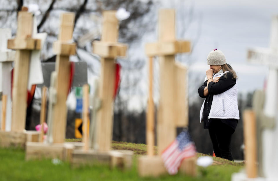 In this Feb. 8, 2019, photo, Joanie Ellison cries while visiting a memorial for Camp Fire victims in Paradise, Calif. Ellison, currently staying on her daughter's couch, hopes to re-settle in Paradise. In the 100 days since a wildfire nearly burned the town of Paradise off the map, Joanie Ellison has made a tearful drive dozens of times to the ruins of her home, resisting the urge to look away from the devastation so she could fully absorb the staggering loss. (AP Photo/Noah Berger)