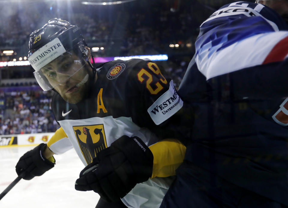 Germany's Leon Draisaitl, left, checks Dylan Larkin of the US, right, during the Ice Hockey World Championships group A match between Germany and the United States at the Steel Arena in Kosice, Slovakia, Sunday, May 19, 2019. (AP Photo/Petr David Josek)