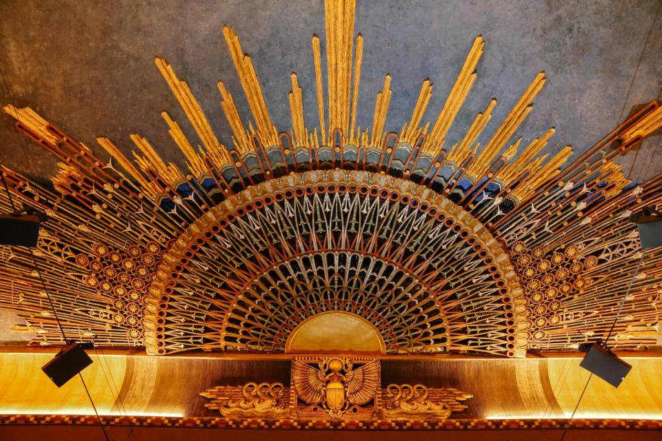 An Egyptian-style sunburst design on the ceiling of a theater.