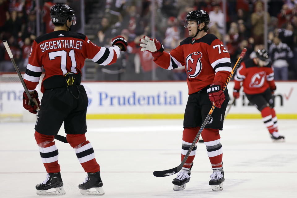 New Jersey Devils right wing Tyler Toffoli is congratulated by Jonas Siegenthaler (71) after scoring an empty-net goal against the Chicago Blackhawks during the third period of an NHL hockey game Friday, Jan. 5, 2024, in Newark, N.J. (AP Photo/Adam Hunger)