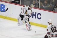 Chicago Blackhawks goaltender Alex Stalock (32) passes the puck during the third period of an NHL hockey game against the Minnesota Wild, Saturday, March 25, 2023, in St. Paul, Minn. Minnesota won 3-1. (AP Photo/Stacy Bengs)