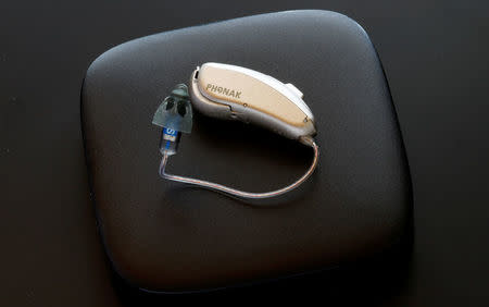 A Phonak Audeo B-Direct hearing aid of Swiss manufacturer Sonova lies on a Phonak TV Connector device in Staefa, Switzerland August 16, 2017. REUTERS/Arnd Wiegmann