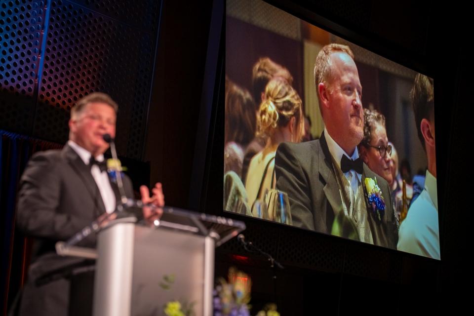 Barry Nelson, on the big screen, receives a Distinguished Service Award from the Salem Area Chamber of Commerce at the 73rd First Citizen Awards Banquet.