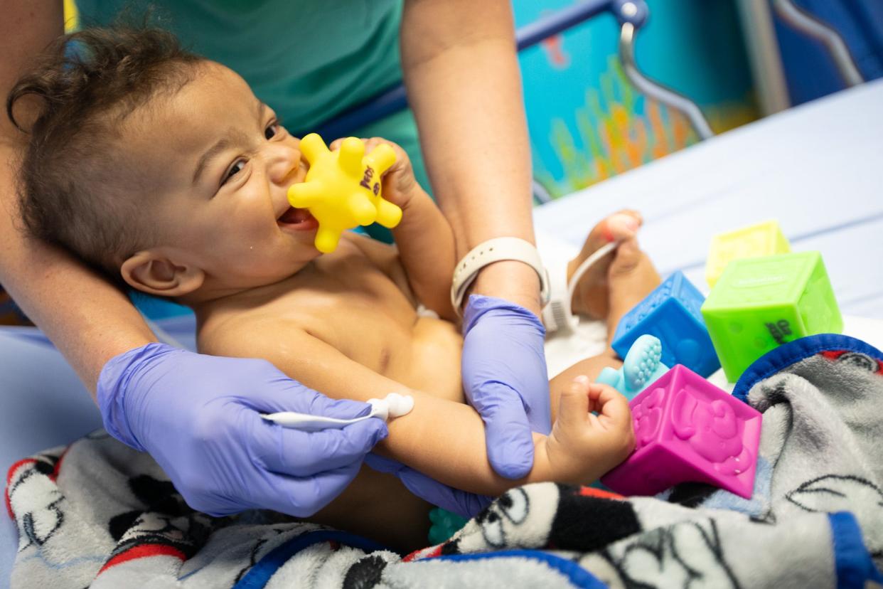 10-month-old Eli gets a glob of topical lidocaine in anticipation of setting an intravenous line for hydrating fluids. Eli was mostly smiles at Health First’s Pediatric Emergency Department at Holmes Regional Medical Center, surrounded as he was by toys, bubbles and dancing lights.