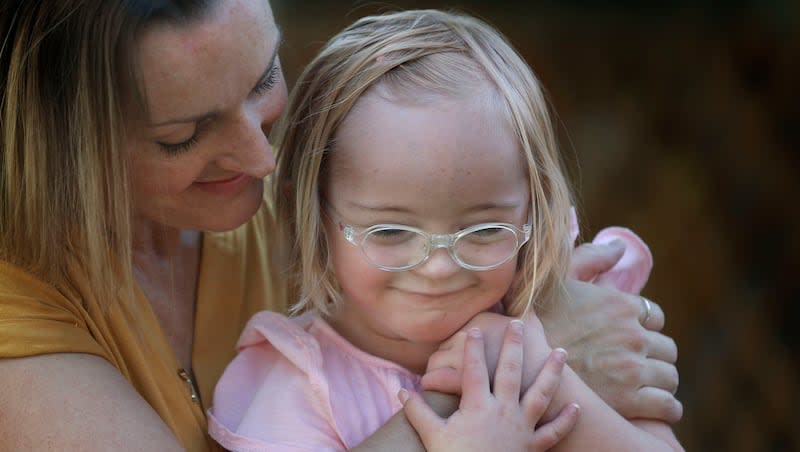 Amanda Longwell hugs her daughter, Tori, at their home in Salt Lake City on Wednesday, July 29, 2020. Thursday is World Down Syndrome Day.