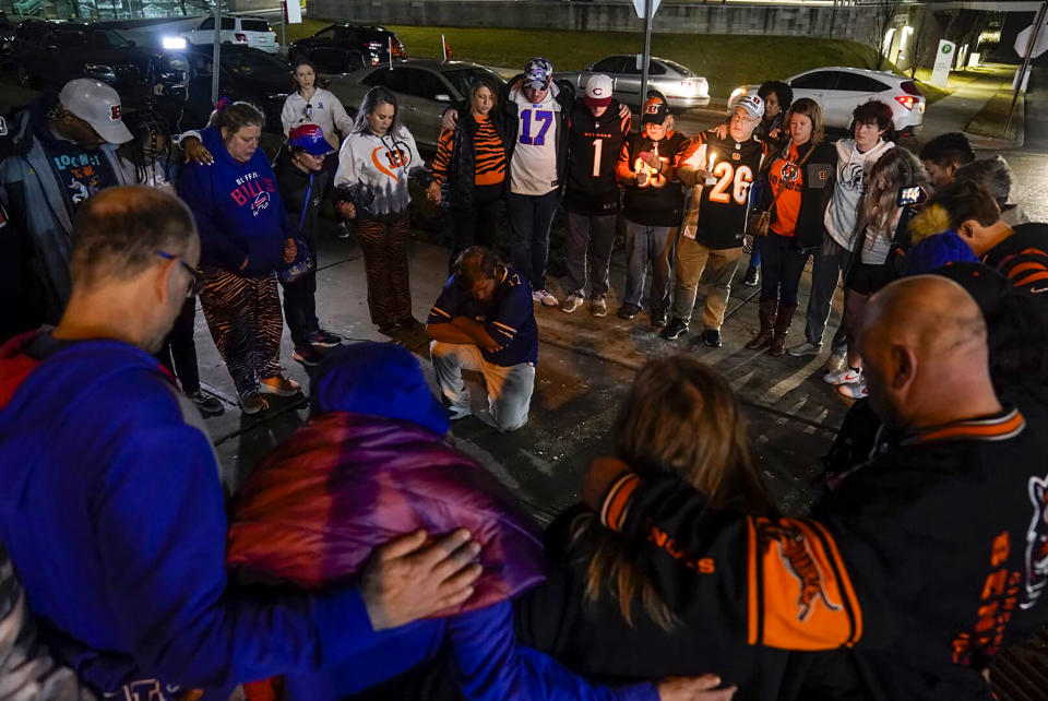 Fans gather outside of University of Cincinnati Medical Center, late Monday, Jan. 2, 2023, in Cincinnati, where Buffalo Bills' Damar Hamlin was taken after collapsing on the field during an NFL football game against the Cincinnati Bengals. (AP Photo/Jeff Dean)