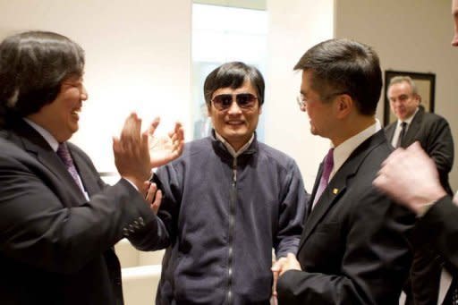 In handout photograph from the US Embassy Beijing Press office, Chinese dissident Chen Guangcheng (C) shakes hands with Gary Locke (R), US ambassador to China in Beijing. Chen appealed to US President Barack Obama to help get him and his family out of China, just hours after leaving the US embassy in Beijing in a deal with Chinese officials