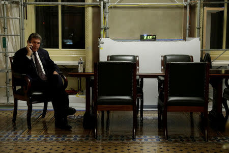 Senator Joe Manchin (D-WV) speaks on a phone outside the room during Democratic Party caucus meeting on Capitol Hill in Washington, U.S., January 19, 2018. REUTERS/Yuri Gripas