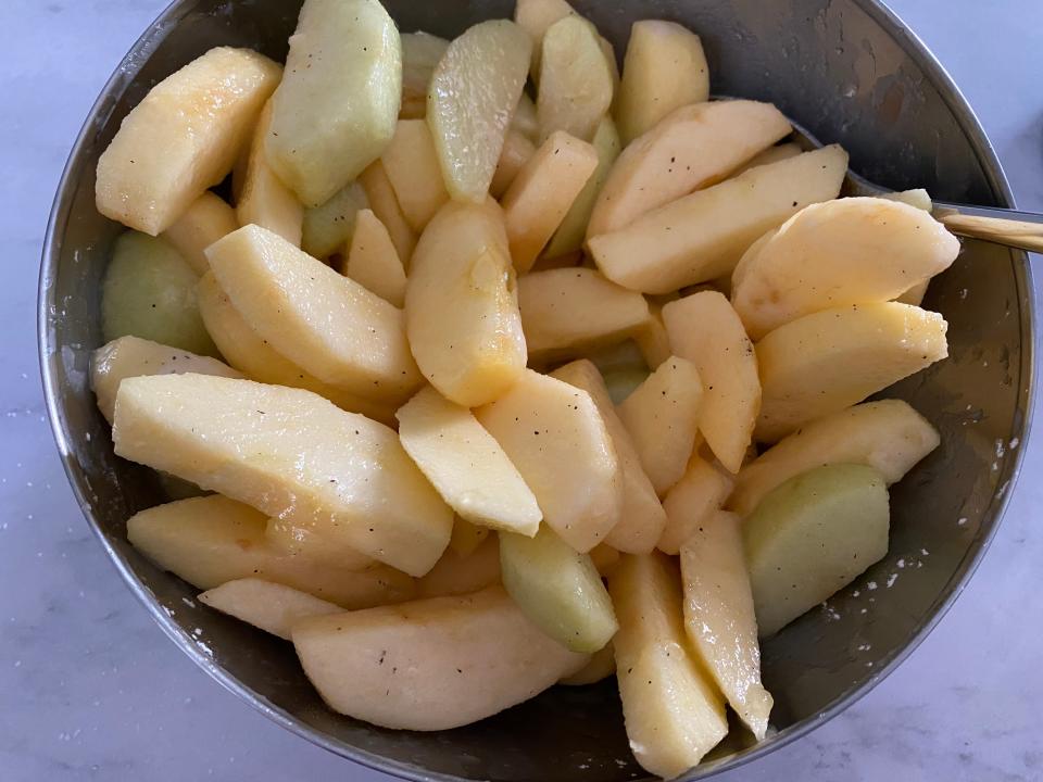 Apple slices in a bowl mixed with spices