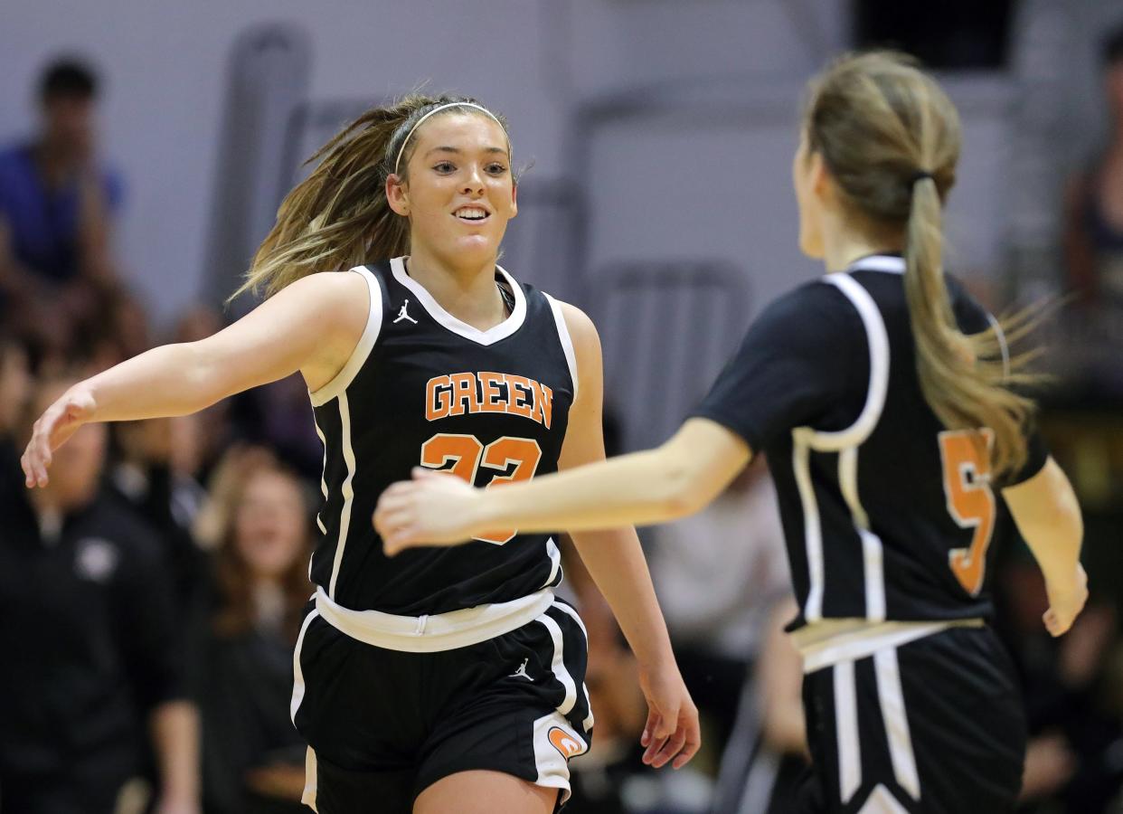 Green's Sydney Shocklee, facing, celebrates with Meredith Viar during the second half of a high school basketball game, Wednesday, Feb. 7, 2024, in Akron, Ohio.