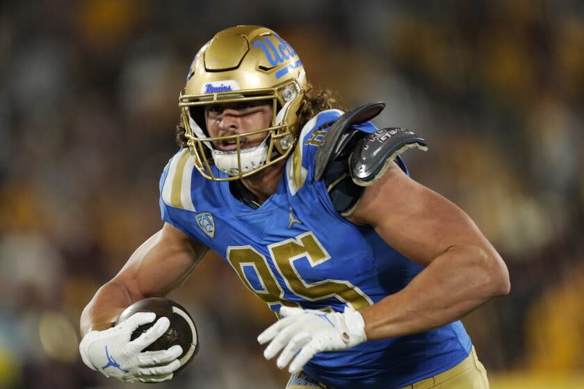 FILE - UCLA tight end Greg Dulcich runs the ball during the second half of the team's NCAA college.