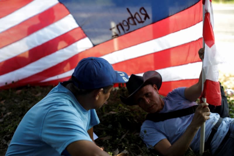 Migrants, mainly from Central America and marching in a caravan, take a break near Frontera Hidalgo, Chiapas