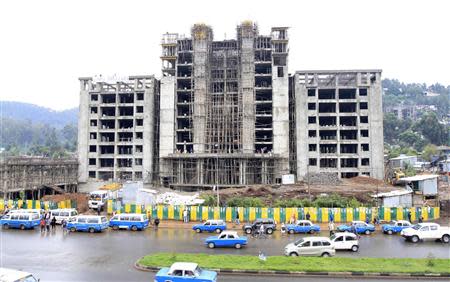 Traffic passes along a street with buildings under construction in Ethiopia's capital Addis Ababa, September 16, 2013. REUTERS/Tiksa Negeri