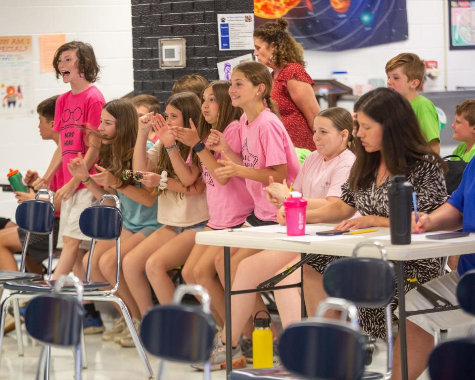 Classmates of the Silver Lake Book Bombers leaped in excitement once they realized the team would win the War on 24 title in the third annual Battle of the Books, held Wednesday at St. Marys Grade School.