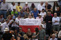 A fan holds a Polish flag with a message for Iga Swiatek, of Poland, during her Italian Open tennis tournament final match against Aryna Sabalenka, of Belarus, at Rome's Foro Italico, Saturday, May 18, 2024. (AP Photo/Alessandra Tarantino)