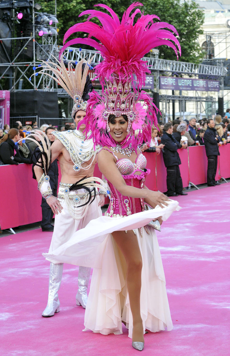 Guests in fancy costumes arrive for the opening ceremony of the 21st Life Ball in front of city hall in Vienna, Austria, on Saturday, May 25, 2013. The Life Ball is a charity gala to raise money for people living with HIV and AIDS. (AP Photo/Hans Punz)