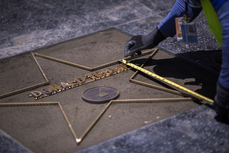 Workers were already hard at work to replace Trump's star after it was destroyed by a vandal on Wednesday. (Photo: DAVID MCNEW via Getty Images)