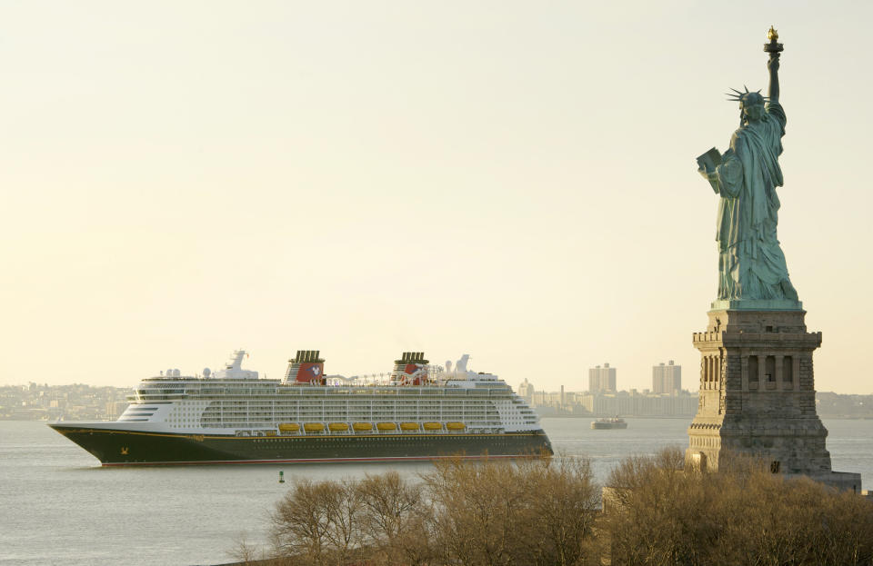 In this Tuesday, Feb. 28, 2012 photo provided by Disney, the Disney Fantasy, the newest ship of Disney Cruise Line, sails past the Statue of Liberty after traveling across the Atlantic from Germany, where it was built. The 4,000-passenger, 14-deck ship with its distinctive mouse ears logo arrived in New York Tuesday after traveling nearly 3,800 miles across the Atlantic Ocean from the shipyards where it was built in Bremerhaven, Germany. The ship, which was christened on Thursday, March 1, will sail on seven-night Caribbean cruises starting March 31 from Port Canaveral, Fla. (AP Photo/Disney, Kent Phillips)