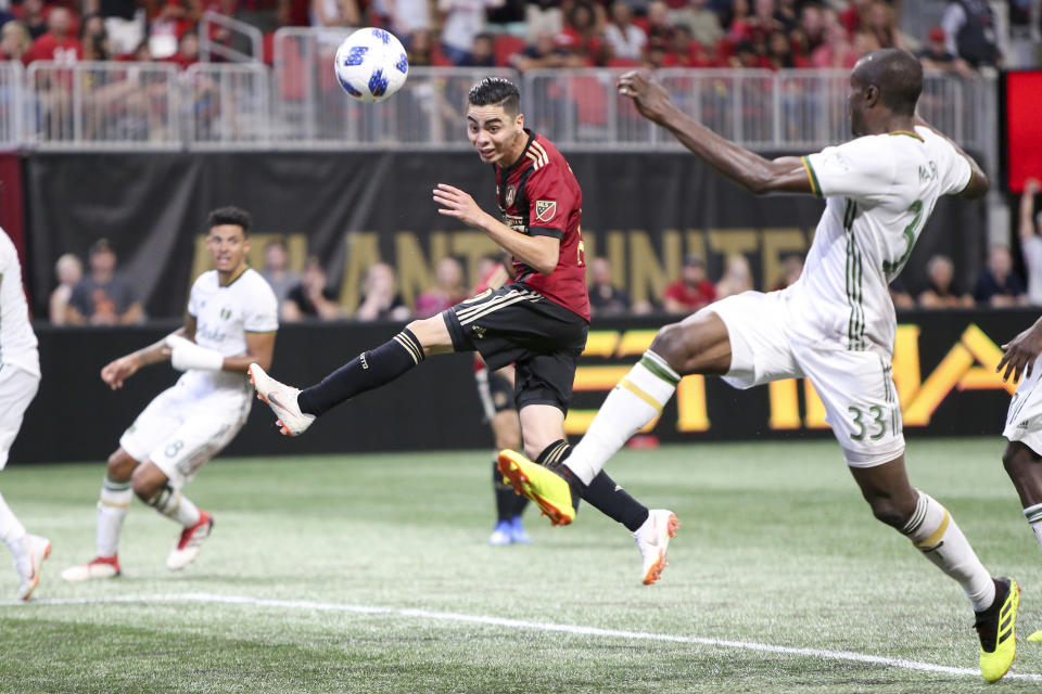 File - In this June 24, 2018, file photo, Atlanta United midfielder Miguel Almiron (10) has a shot defended by Portland Timbers defender Larrys Mabiala (33) in the second half of an MLS soccer match in Atlanta. Before an expected crowd of more than 70,000, Atlanta United will host the Portland Timbers in the MLS Cup championship game Saturday, Dec. 8, 2018. (AP Photo/Brett Davis, File)