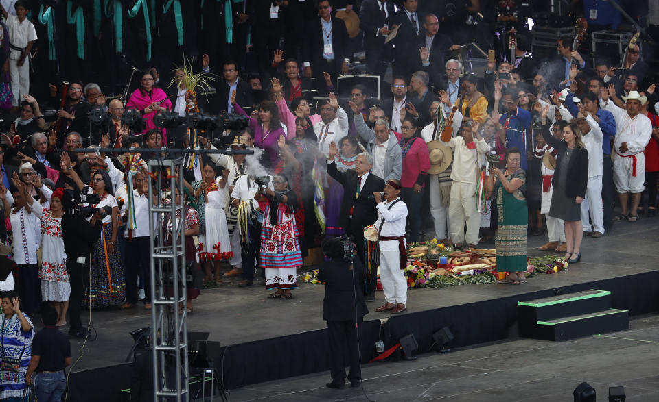 Mexico's newly sworn-in President Andres Manuel Lopez Obrador takes part in a traditional indigenous ceremony at the Zocalo, in Mexico City, Saturday, Dec. 1, 2018. Mexicans are getting more than just a new president Saturday. The inauguration of Lopez Obrador will mark a turning point in one of the world's most radical experiments in opening markets and privatization. (AP Photo/Marco Ugarte)