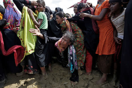 A Rohingya refugee reacts as people scuffle while waiting to receive aid in Cox's Bazar, Bangladesh, September 26, 2017. REUTERS/Cathal McNaughton