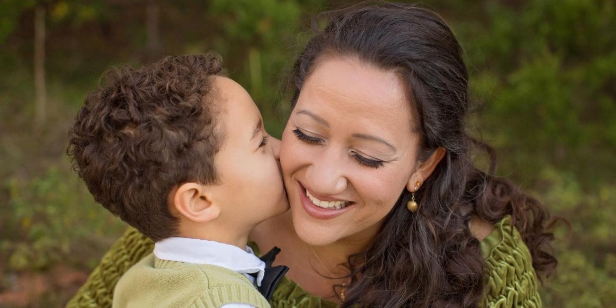 turning 3 with an iep - little boy kissing mom on the cheek