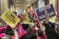 Abortion protesters on both sides pack the halls outside the Minnesota Senate chamber on Friday, Jan. 27, 2023, at the State Capitol in St. Paul, Minn. The Minnesota Senate is debating a bill Friday to write broad protections for abortion rights into state statutes, which would make it difficult for future courts to roll back. (AP Photo/Steve Karnowski)