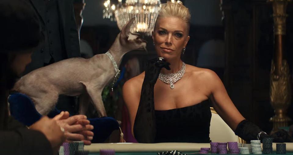 Hannah Waddingham is a glamorous villain with a hairless cat as she plays high stakes poker in Rakuten’s Super Bowl commercial. - Credit: Rakuten/Mega