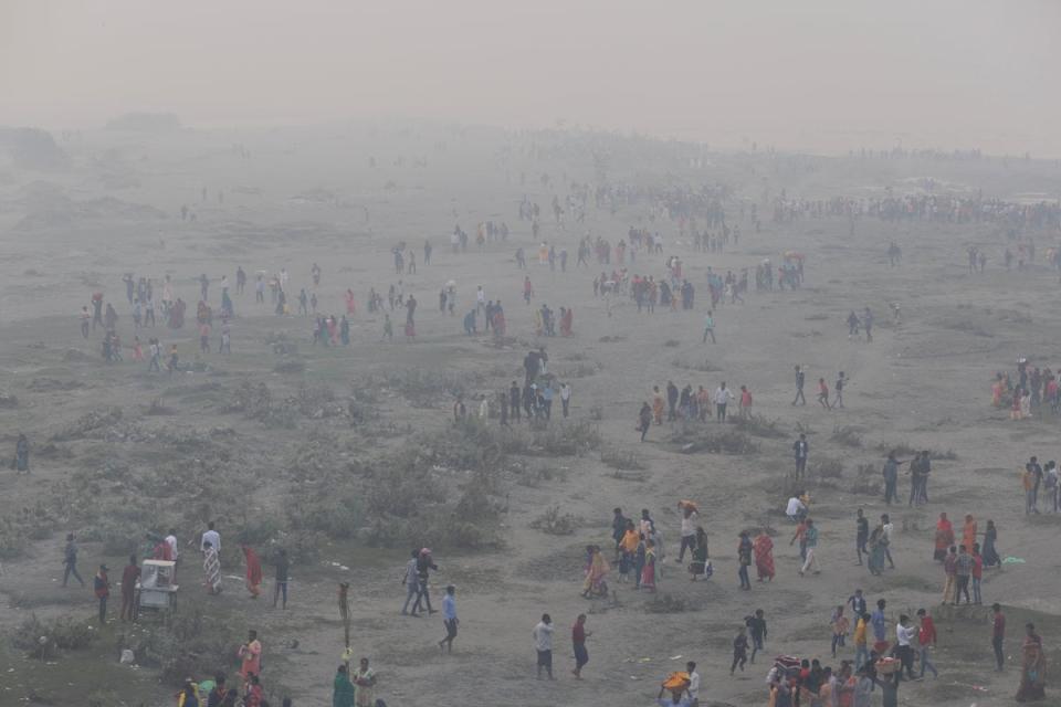 Hindu devotees gather to worship on the banks of the Yamuna river (Reuters)