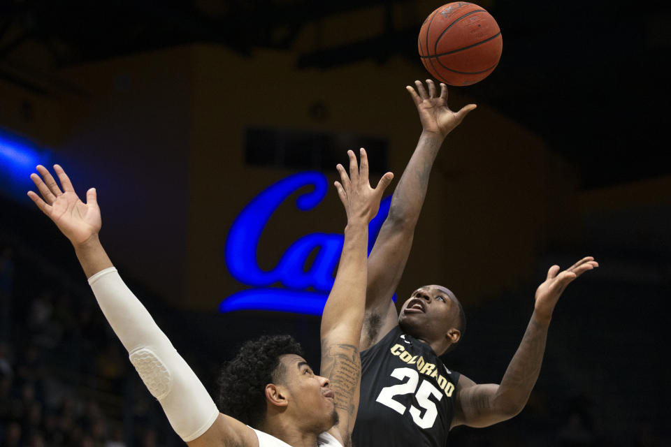 FILE - In this Thursday, Feb. 27, 2020, file photo, Colorado guard McKinley Wright IV (25) shoots over California forward Andre Kelly during the second half of an NCAA college basketball game, in Berkeley, Calif. Wright has decided to return for his senior season after testing out the NBA draft process. He was a member of the All-Pac-12 first team and all-defensive team in a season that was shut down just before the NCAA tournament due to the coronavirus pandemic. (AP Photo/D. Ross Cameron, File)