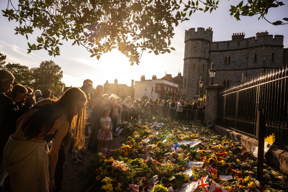 People gather at the gates of Windsor Castle to lay flowers in tribute to Queen Elizabeth II. (Getty Images)