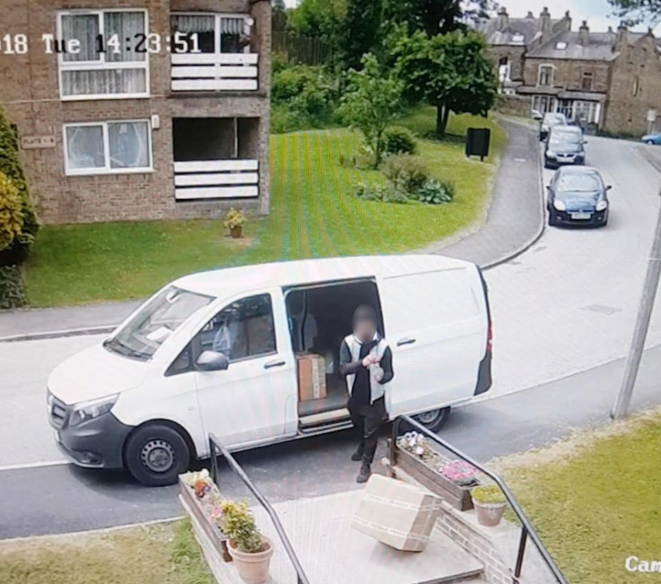 The driver is caught on CCTV throwing the boxes (Picture: Caters)