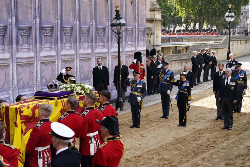 LONDON, ENGLAND - SEPTEMBER 14: King Charles III, Princess Anne, Princess Royal, Prince William, Prince of Wales, Prince Harry, Duke of Sussex and Prince Andrew, Duke of York watch as the bearer party carry the coffin of Queen Elizabeth II into Westminster Hall, on September 14, 2022 in London, United Kingdom. Queen Elizabeth II's coffin is taken in procession on a Gun Carriage of The King's Troop Royal Horse Artillery from Buckingham Palace to Westminster Hall where she will lay in state until the early morning of her funeral. Queen Elizabeth II died at Balmoral Castle in Scotland on September 8, 2022, and is succeeded by her eldest son, King Charles III. (Photo by Danny Lawson - WPA Pool/Getty Images)