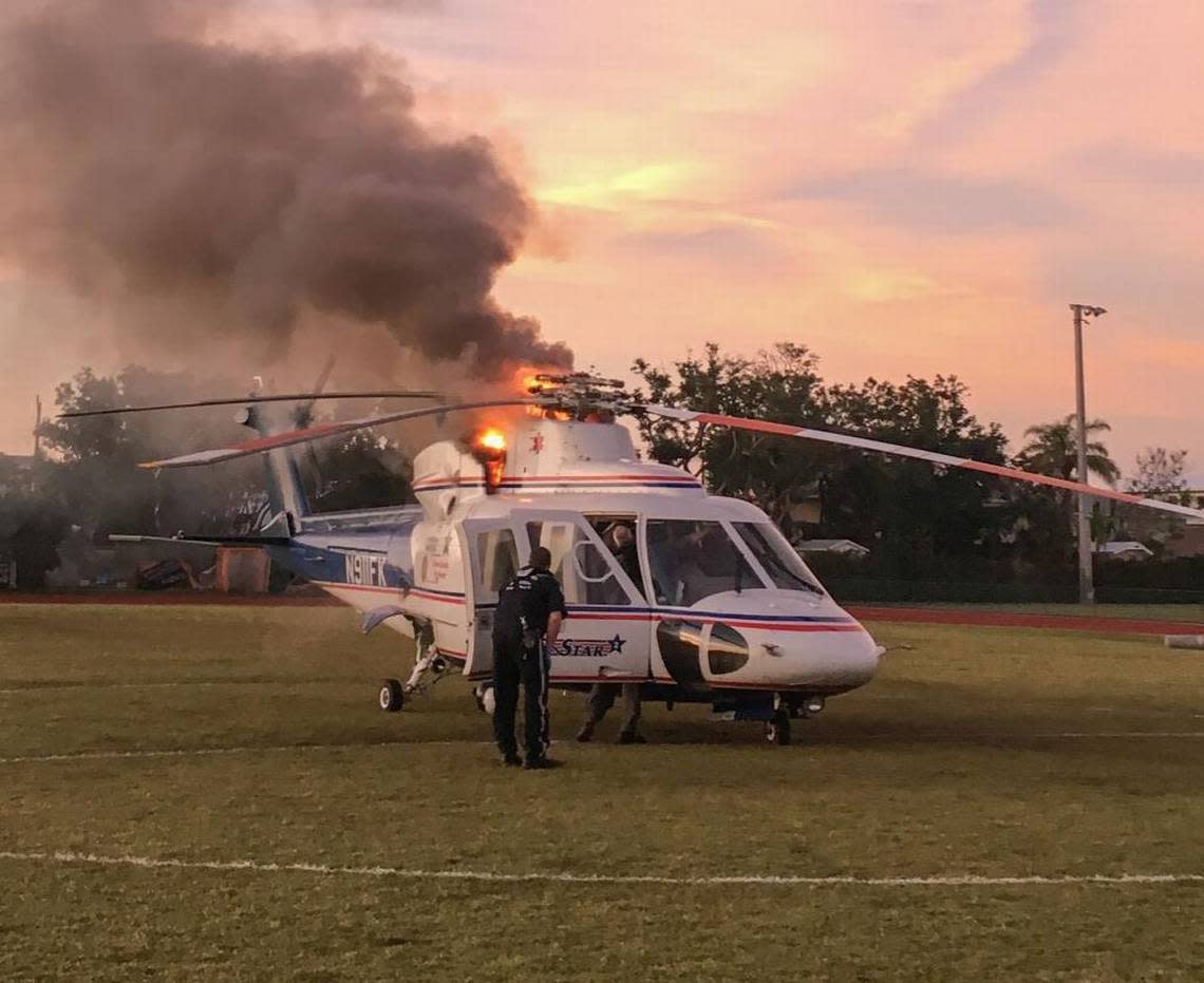 Smoke and flames billow out from beneath the rotors of one of Monroe County’s Trauma Star medical helicopters on the soccer field of Coral Shores High School in Plantation Key.