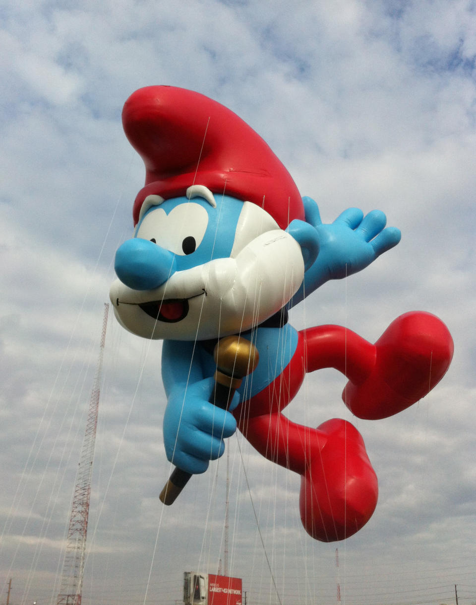 FILE - In this Nov. 10, 2012 file photo provided by Macy’s, the Papa Smurf balloon floats over the Meadowland’s race track during a test flight in East Rutherford, N.J. Papa Smurf is one of three new balloons to be featured in the 2012 Macy’s Thanksgiving Parade. (AP Photo/Macy’s, Inc.)