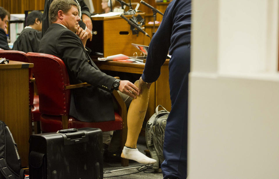 A prosthetic leg is handed to the court in Pretoria, South Africa, Thursday, April 17, 2014. Pistorius is charged with the murder of his girlfriend, Reeva Steenkamp, on Valentines Day in 2013. (AP Photo/Alet Pretorius, Pool)