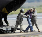 <p>A woman is helped off of a military helicopter at the Boulder Municipal Airport in Boulder, Colo., on on Monday, Sept. 16, 2013, after being rescued. Thousands of people remained stranded by high water and washed out roads in the state. (AP Photo/Ed Andrieski)</p>