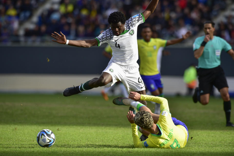 Nigeria's Daniel Daga, top, and Brazil's Marlon Gomes fight for the ball during a FIFA U-20 World Cup Group D soccer match at the Diego Maradona stadium in La Plata, Argentina, Saturday, May 27, 2023. (AP Photo/Gustavo Garello)