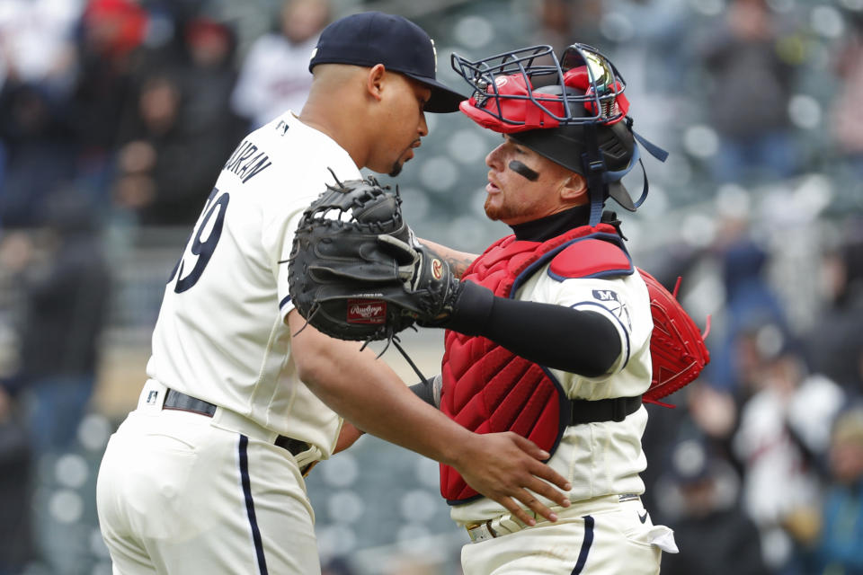 Minnesota Twins relief pitcher Jhoan Duran, left, and catcher Christian Vazquez celebrate a win over the Kansas City Royals in a baseball game Sunday, April 30, 2023, in Minneapolis. (AP Photo/Bruce Kluckhohn)