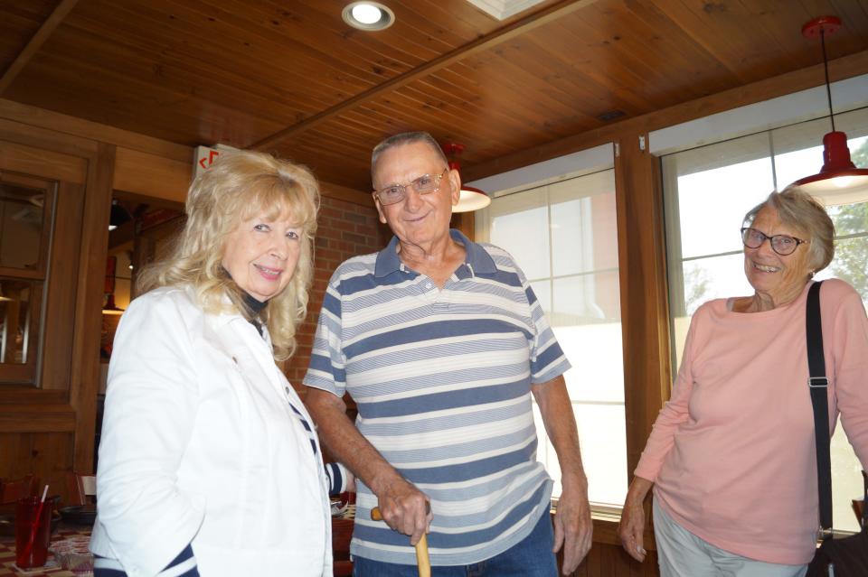 Marjorie (Morris) Patterson, Leonard Walton and Linda (Huber) Crossen catch up during the Hayesville High School class of 1961 reunion, recently.