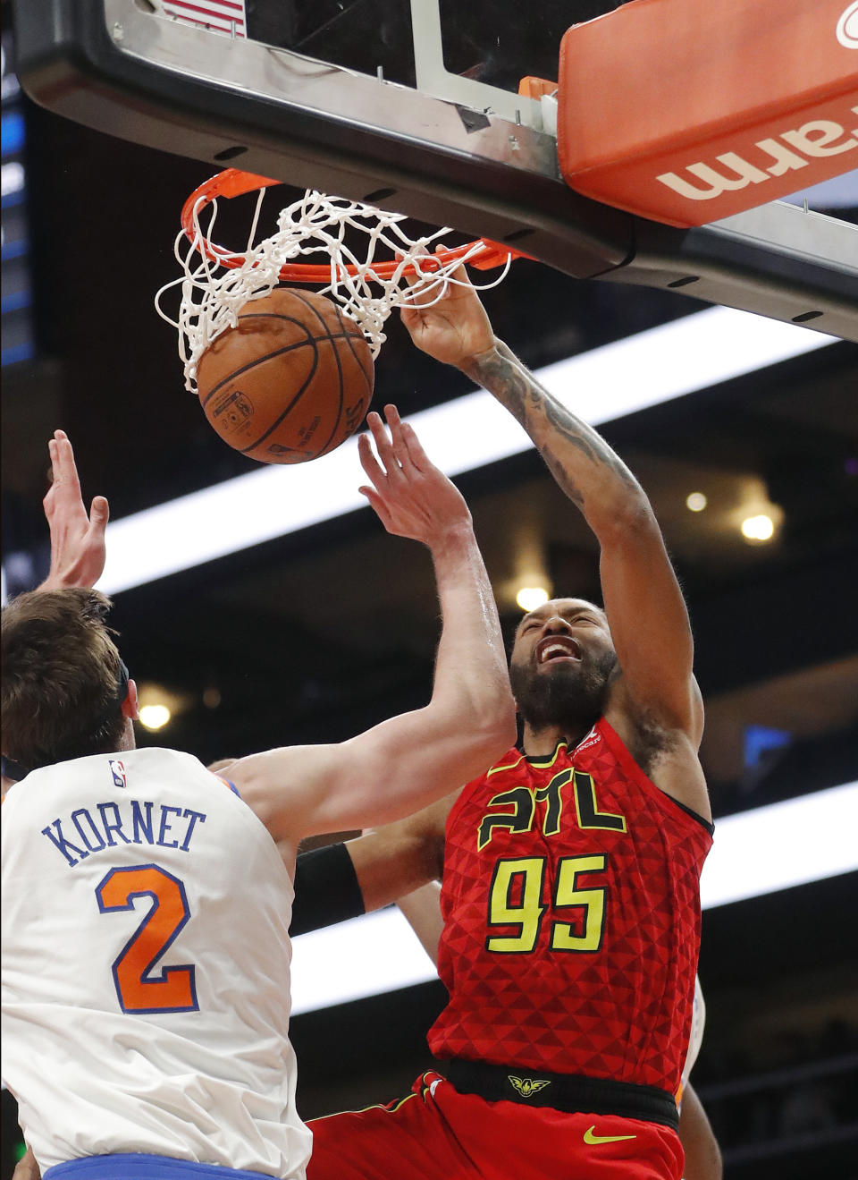 Atlanta Hawks forward DeAndre' Bembry (95) scores as New York Knicks forward Luke Kornet (2) defends during the first half of an NBA basketball game Thursday, Feb. 14, 2019, in Atlanta. (AP Photo/John Bazemore)