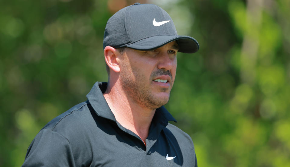   Koepka stares on in a black top 