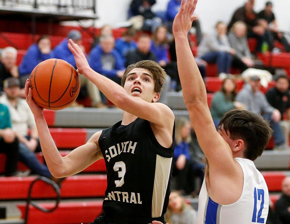 South Central High School's Isaac Blair (3) drives in for a shot against Danbury High School's James Morissey (12) during high school boys basketball action at Shelby High School Wednesday, Feb. 22, 2023. TOM E. PUSKAR/ASHLAND TIMES-GAZETTE