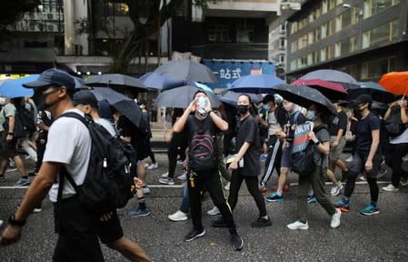 Anti-government demonstrators march in protest against the invocation of the emergency laws in Hong Kong