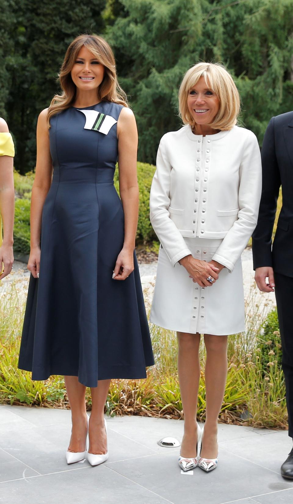 The First Ladies, Brigitte Macron and Melania Trump, stepped out in differing pieces that incorporated the color of unity.