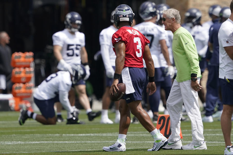 Seattle Seahawks head coach Pete Carroll, right, walks with quarterback Russell Wilson (3) during NFL football practice Wednesday, July 28, 2021, in Renton, Wash. (AP Photo/Ted S. Warren)