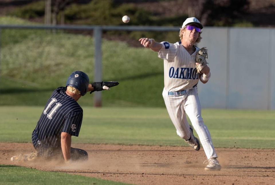 Oakmont shortstop KC Tibbits throws to first for a double play during the Sac-Joaquin Section DIII championship game with Central Catholic at Islanders Park in Lathrop, Calif., Thursday, May 23, 2024. Oakmont won the game 3-0.