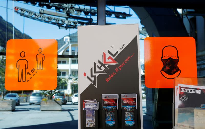 FILE PHOTO: Signs are seen at the entrance of a lift station in the Tyrolean ski resort of Ischgl